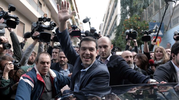 Alexis Tsipras, the leader of the leftist Syriza party, greets supporters in Athens. 
