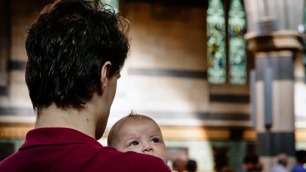 A father and baby at the 9am Christmas service at St Paul's Cathedral. 