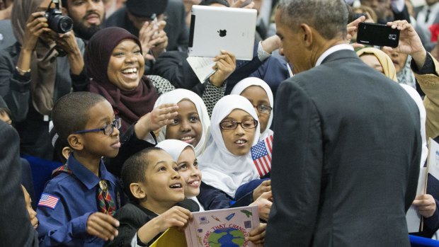 President Barack Obama greets children from al-Rahmah school and other guests during his visit to the Islamic Society of Baltimore on Wednesday.