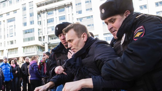 Alexei Navalny is detained by police in downtown Moscow on Sunday.