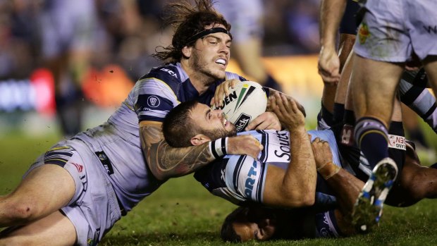 Well held: Sharks forward Wade Graham is tackled just short of the line by Cowboys rival Ethan Lowe.
