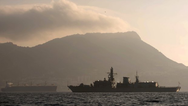 Britain's Royal Navy ship HMS Westminster, right, sails along the Gibraltar stretch in 2013, backdropped by the tiny territory on the southern tip of the Iberian peninsula.