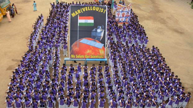 Indian school children stand in formation as they celebrate the success of India's Mars Orbiter Mission, at a school in Chennai 