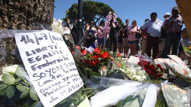 Floral tributes are laid out near the site of the truck attack in the French resort city of Nice on Friday.