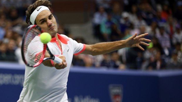 Beaten: Roger Federer returns a forehand to Novak Djokovic.