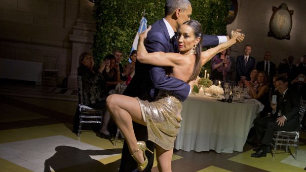 President Barack Obama does the tango with a dancer during the state dinner in Buenos Aires, Argentina on Wednesday.