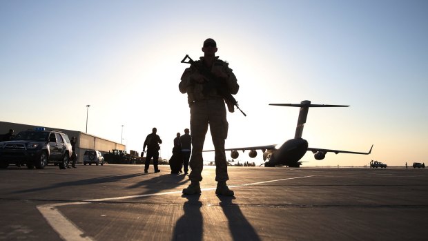 A soldier stands guard near a C17 military transport plane that brought then US defence secretary Chuck Hagel to Kandahar, Afghanistan, in December 2013.