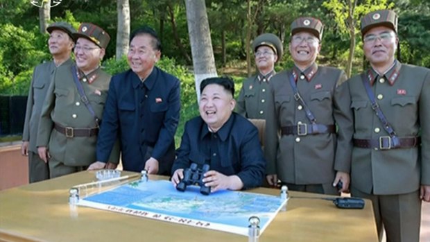 Kim Jong Un, centre, watches the test launch of missile at an undisclosed location in North Korea.