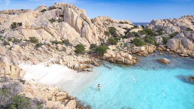 Swimming in one of Sardinia's pristine beaches.