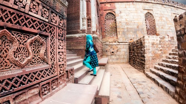 Woman at ancient Qutub Minar Complex in Delhi, India.