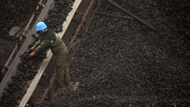 A worker monitors coal being carried along conveyor ramps at a coal mine near Ordos in northern China's Inner Mongolia Autonomous Region last year. 