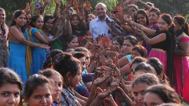 Mahesh Savani with some of the hundreds of brides he has helped. 