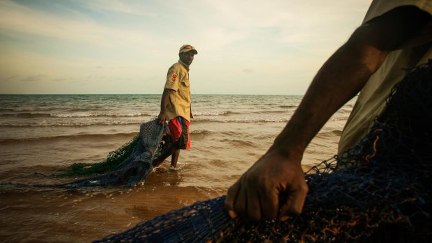 Ranger Dukpirri Marwali pulls ghost nets discarded from fishing boats ashore in the Laynhapuy Indigenous Protected Area at Yilpara on the Arnhem Land coast, NT.