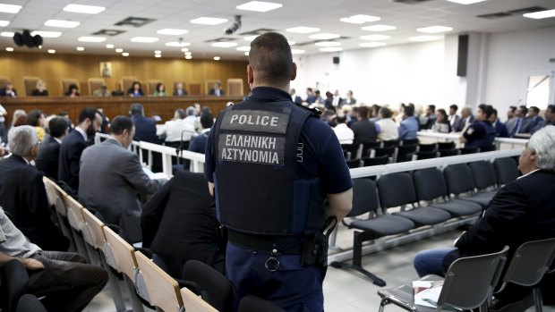 A police officer stands guard at the court room where the trial of members and leaders of Greece's far-right Golden Dawn party takes place, in Koridallos prison, near Athens.