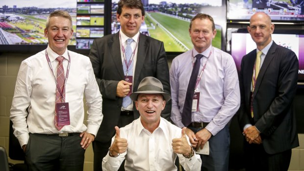 If the hat fits: Cassidy in the stewards’ room on his last day as a jockey with stipes Rob Montgomery, Terry Bailey, Robert Cram and Kim Kelly.