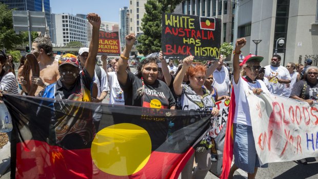 Demonstrators gather to protest the deaths of indigenous Australians in custody.