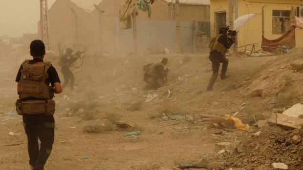Iraqi security forces defend their headquarters against attacks by Islamic State extremists in the eastern part of Ramadi in Anbar.