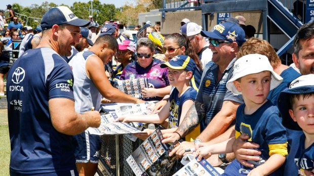 Scott Bolton of the Cowboys signs autographs before a Townsville training session open to the public ahead of the grand final.