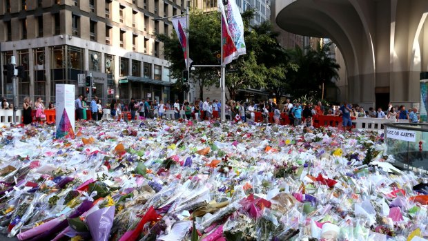 People line up to leave flowers at Martin Place.