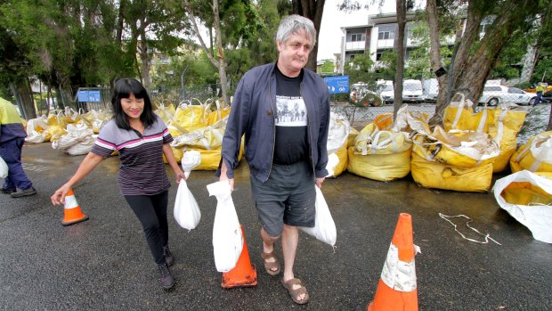 Anna and Perry Burt collecting sandbags from Newmarket SES Depot on Friday.