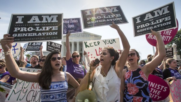 Anti-abortion activists demonstrate in front of the Supreme Court as the justices struck down the Texas law.
