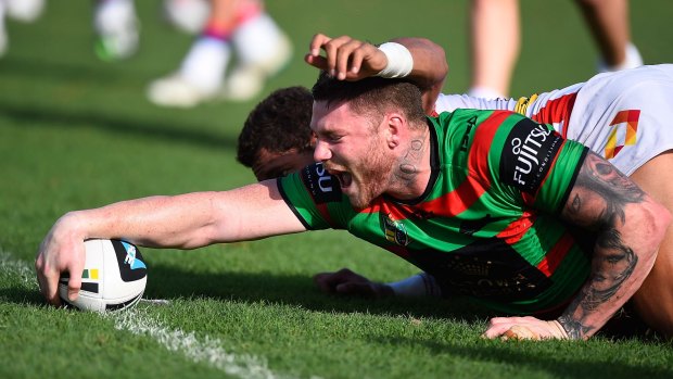 Rub it in: Chris McQueen scores for the Rabbitohs against the Knights.