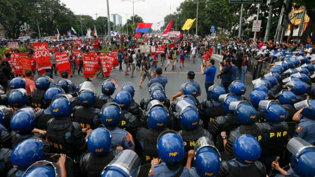 Riot police watch as protesters leave after a rally near US Embassy in Manila to oppose alleged US meddling in Philippine domestic affairs.