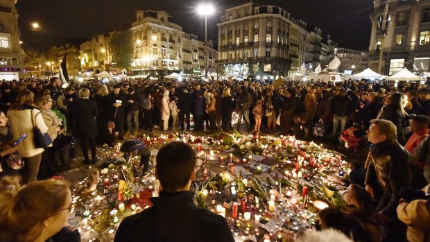 Hundreds of people come together at Place de la Bourse in Brussels to mourn the victims. 