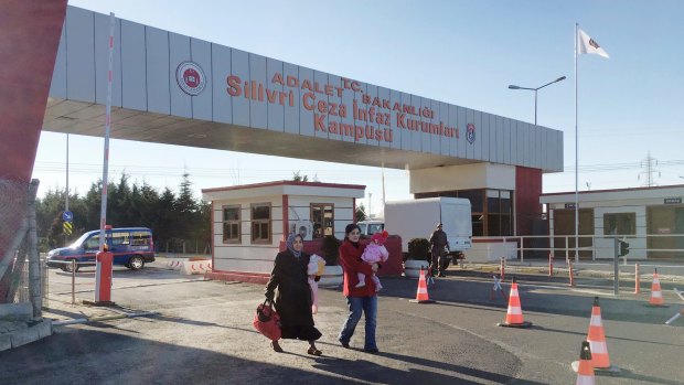 People at the entrance of Silivri Prison and courthouse on the outskirts of Istanbul, where 29 police officers are on trial over July's failed coup in Turkey. 