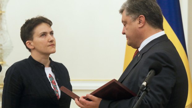Ukrainian President Petro Poroshenko awards Nadiya Savchenko the Hero of Ukraine medal.