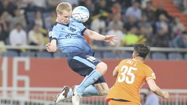 Sky Blue Matthew Simon competes for the ball with Dai Lin of Shandong Luneng.
