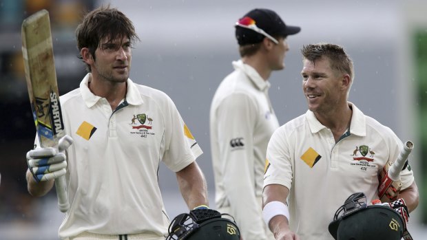 Joe Burns and David Warner leave the field after rain stopped play on the third day of the first Test on Saturday.