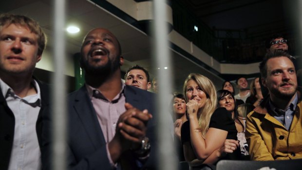 Spectators react as they watch a colleague fight during the "Brawl at the Hall". 