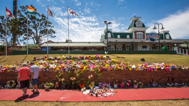 Floral tributes outside Dreamworld after four people died on a ride.