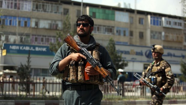 Afghan security personnel arrive at the site of a suicide bombing in Kabul, Afghanistan, on Tuesday.