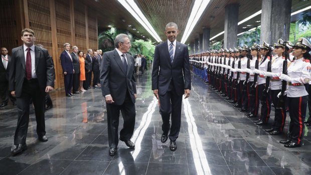 US President Barack Obama and Cuban President Raul Castro review troops before bilateral meetings at the Palace of the Revolution.