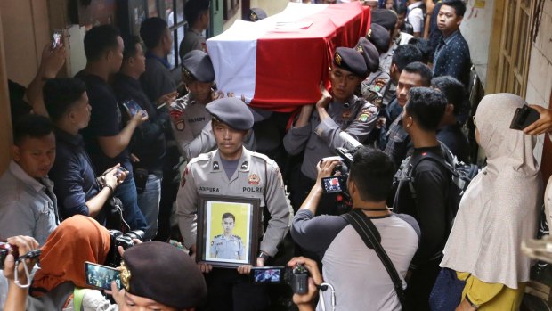 Police officers carry the coffin of their colleague Sergeant Gilang Imam Adinata who was killed in Wednesday's 
bombings in Jakarta.