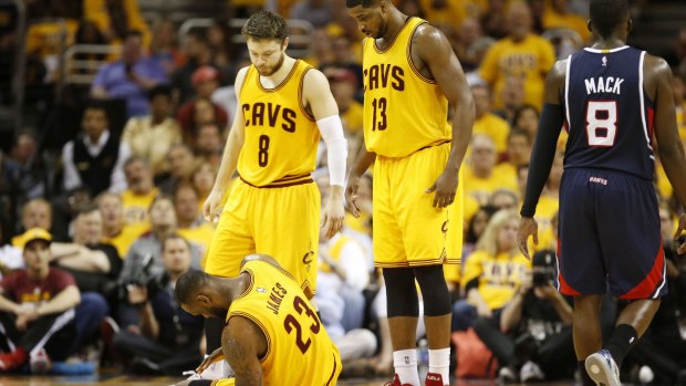 Helping hand: Matthew Dellavedova abd Tristan Thompson come to the assistance of LeBron James in game three.