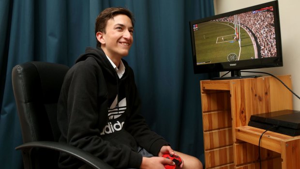 David Connolly, 15, playing the new AFL Evolution video game.