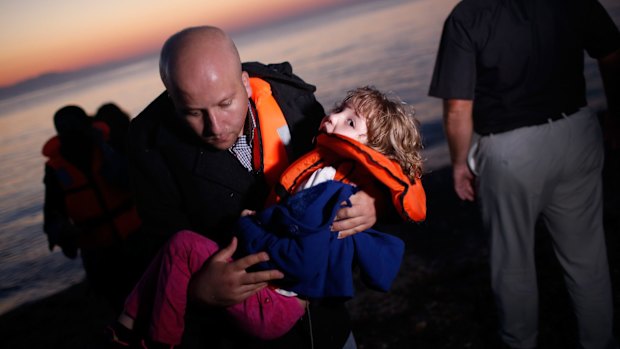 A migrant family from Syria arrives  on Kos after crossing the Aegean Sea from Turkey in late August. 