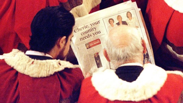 Members of the House of Lords read a newspaper article about Labour women MPs' fashion sense before the Queen delivers her speech in 1997.