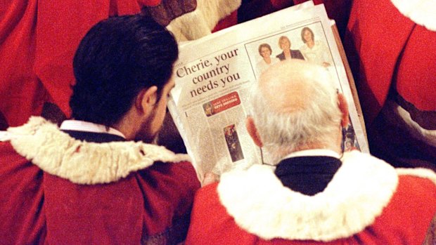 Members of the House of Lords read a newspaper article about Labour women MPs' fashion sense before the Queen delivers her speech in 1997.