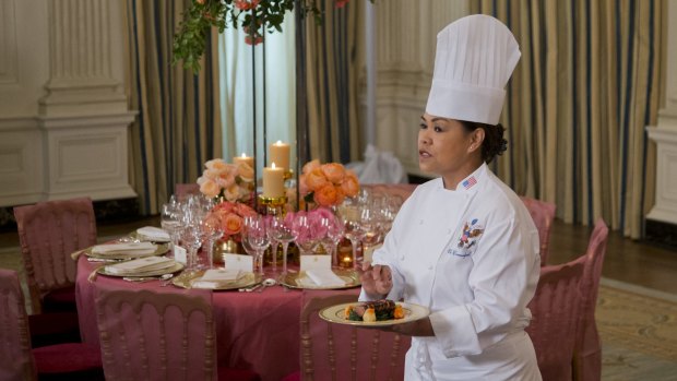 White House executive chef Cristeta Comerford with the main course for the banquet planned for China's President Xi Jinping on Friday: a grilled cannon of Colorado lamb garnished with garlic fried milk.