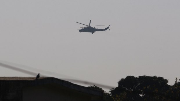 An Indian air force helicopter flies over Pathankot air base.