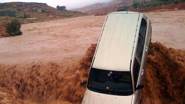 Powerful surge: A car is carried away by flood waters in the southern region of  Ouarzazate in Morocco. 