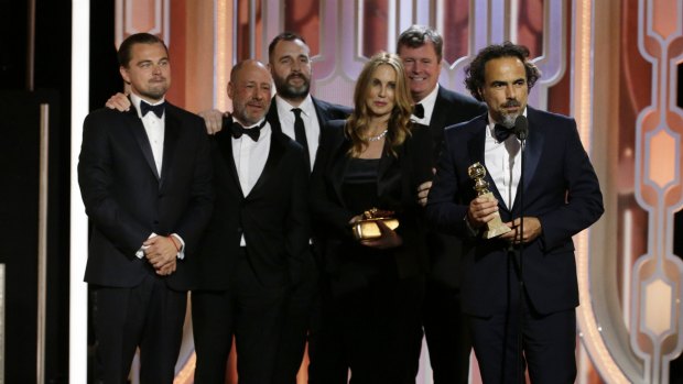 The crew of The Revenant, as director Alejandro G. Inarritu, right, accepts the award for best motion picture drama. 