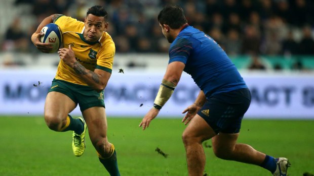The joy of running: Wallabies star Israel Folau, seeking rare space, takes on France’s Alexandre Menini in Paris this month.