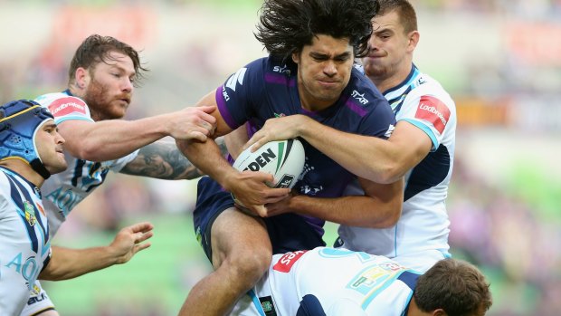 Evasive action: Tohu Harris of the Storm under pressure from all angles during clash with the Titans at AAMI Park.