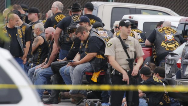 A McLennan County deputy stands guard near a group of bikers in Waco.