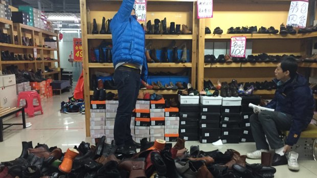 "Five years ago, I used to be able to clear 7000 to 8000 yuan in sales a day. Now I sell in a week what I used to sell in a day," says one stall owner selling leather shoes. 